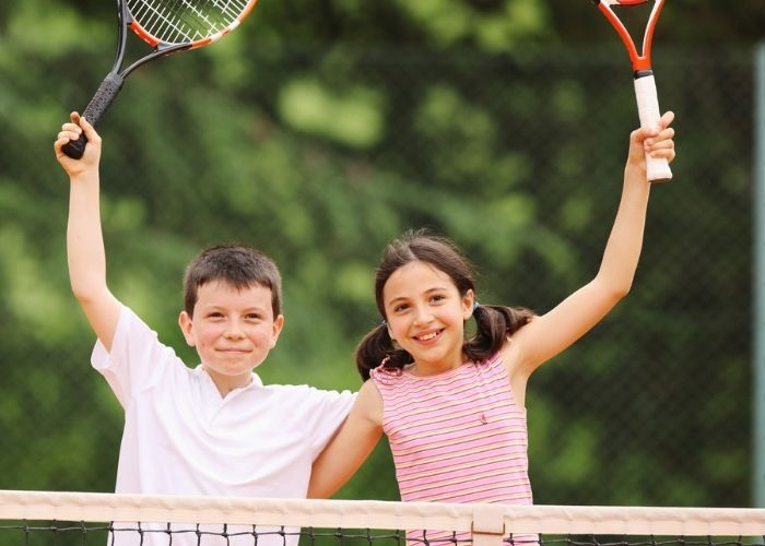 Two children enjoying Tennis Club Activities