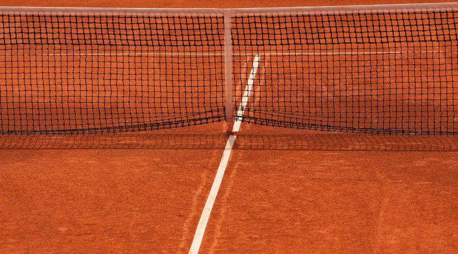 Playing On A Clay Tennis Court