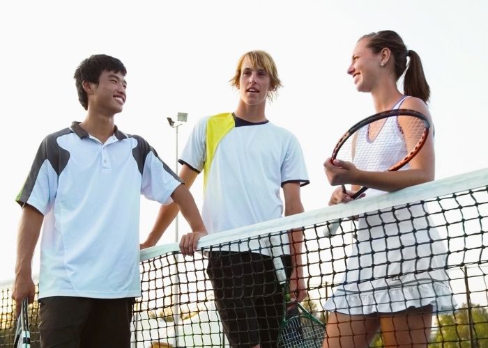 Tennis club members on court