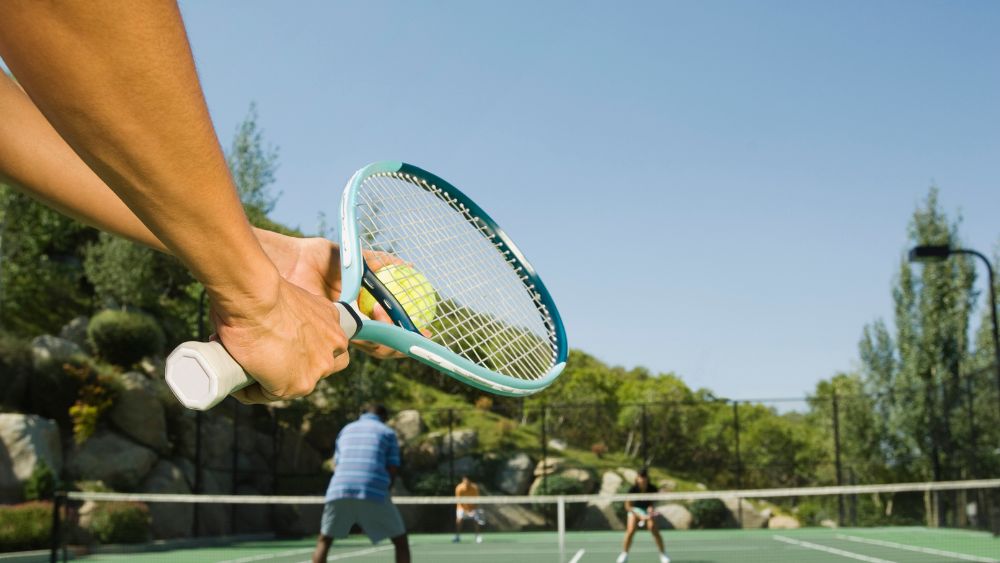 person serving a tennis ball